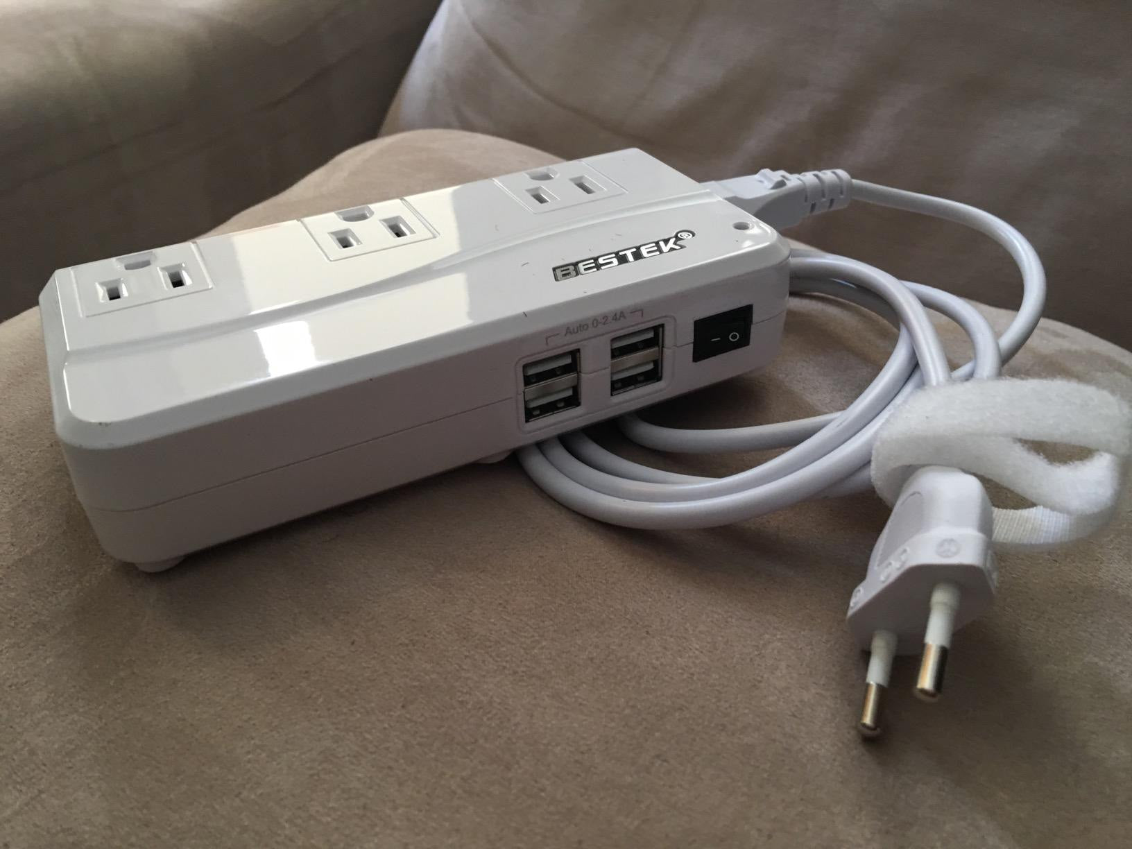 Review photo of a white BESTEK travel converter with its cable and European plug.