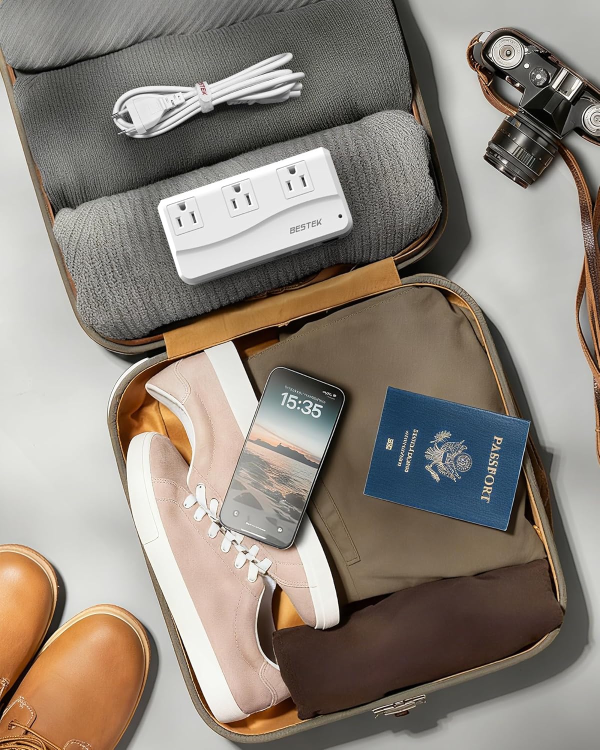 BESTEK 300W travel voltage converter — converter being packed with travel accessories