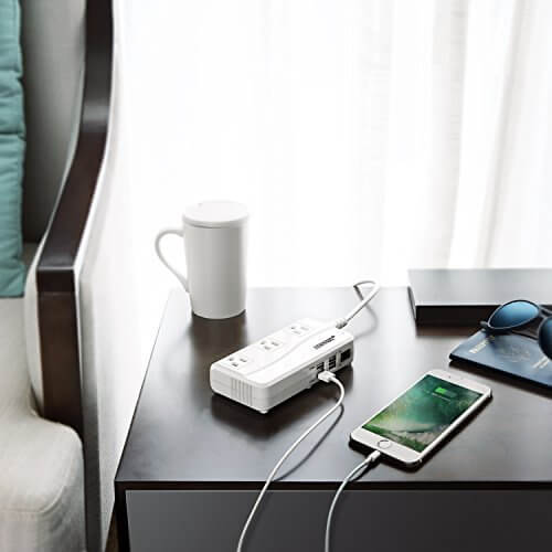 BESTEK 250W travel voltage converter — converter charging devices on a hotel desk
