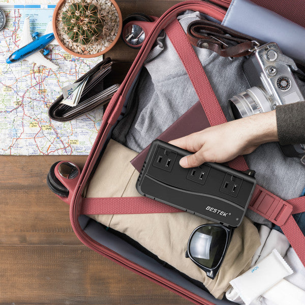 BESTEK travel voltage converter — black converter being packed into a suitcase